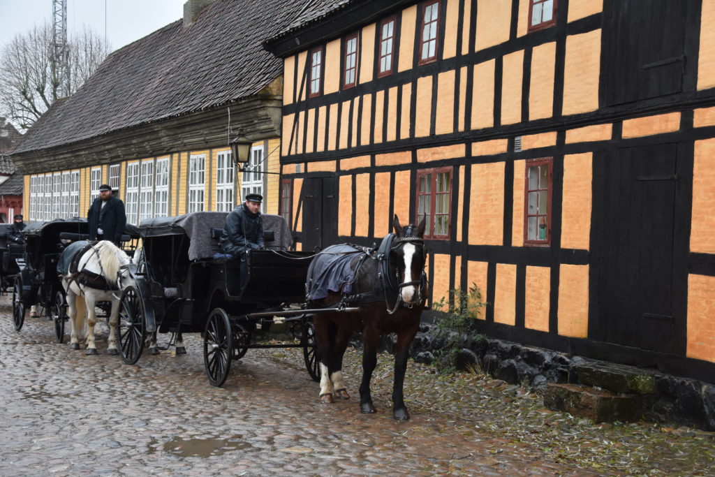 Horse-drawn Carriage down the cobblestoned streets of Den Gamle By in Aarhus, Denmark