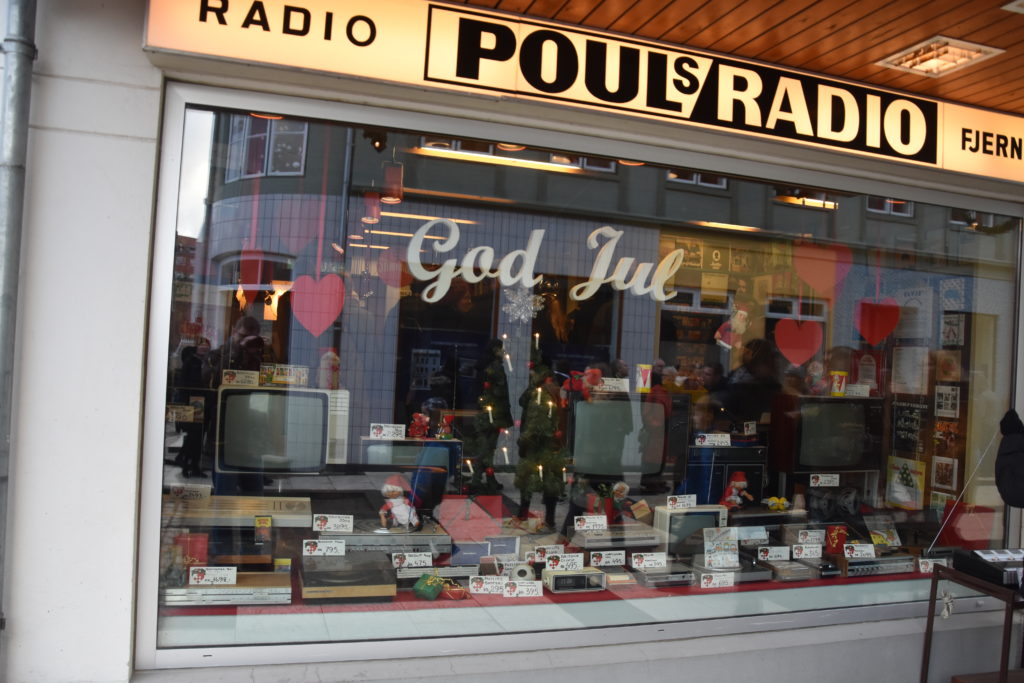 Electronics store decorated with "God Jul" or Merry Christmas, red hearts and Christmas nisser